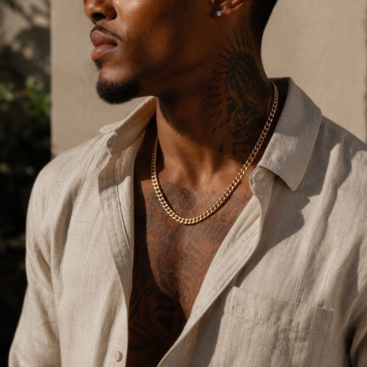 Side view of model styling the Matzzo 5mm 18 gold Cuban chain with men's streetwear